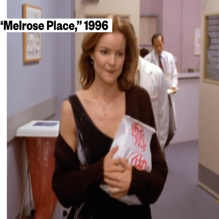 Woman holding a package in a hospital hallway from a scene in 